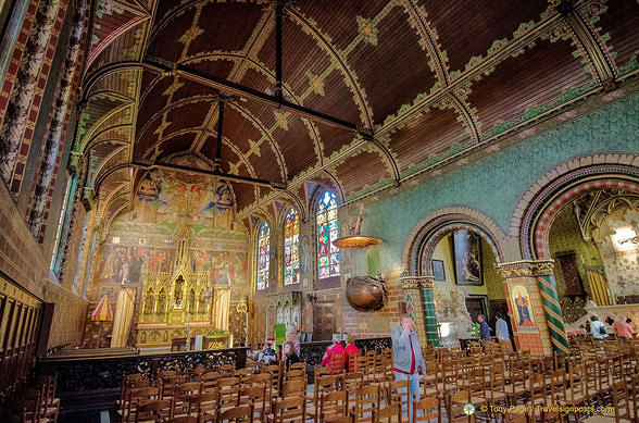 The large wall painting behind the altar shows many scenes