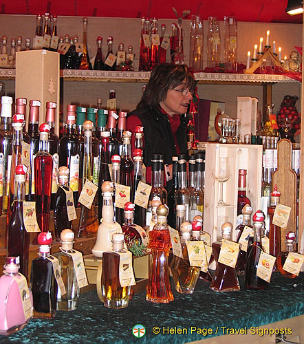 Cologne Weihnachtsmarkt stall selling colorful bottles of liqueur