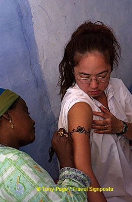 Tourists having their tattoo done