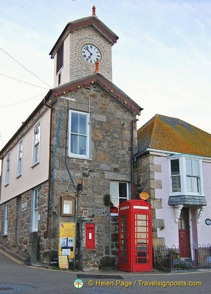 The towering Mousehole harbour office with the Post Office next to it