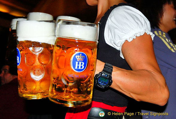 The beer mugs are bigger than this girl's arm