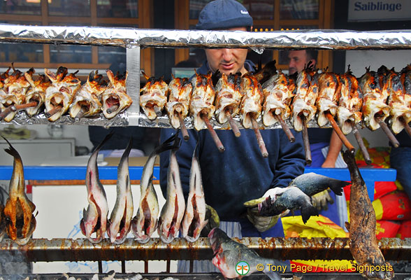 Cooked steckerlfisch kept warm over the grill