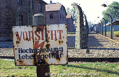 A camp fence sign warning against high voltage