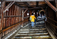 The covered passageway protects villagers making their way to the church