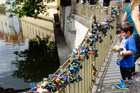 Lovers' padlocks adorn this railing near Charles Bridge