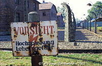 A camp fence sign warning against high voltage