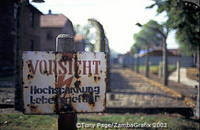 A camp fence sign warning against high voltage