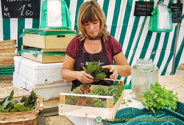 Stallholder packing up her herbs