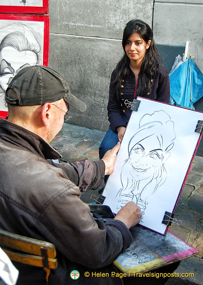 Place du Tertre is known for its artists who paint tourists like this woman