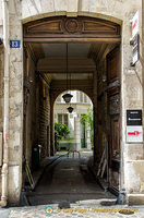 This open wooden door provides a peak into the apartment block